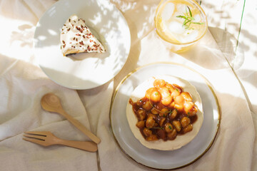 Caramel macadamia cheese pie, Banoffee pie and iced honey lemon soda with sunlight and shadow from a tree in backyard garden.