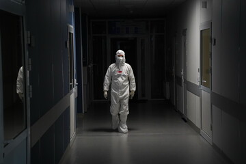Almaty, Kazakhstan - 09.03.2021 : A doctor walks down a dark corridor in a hospital
