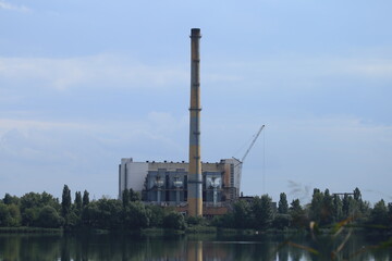 Factory with a chimney by the lake