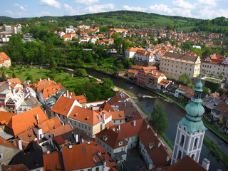 Fototapeta na wymiar Townscape of beautiful Cesky Krumlov in orange color roofs and green in sunny day
