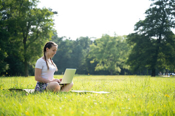 Outdoor online business technology. Student girl work with laptop tablet, computer in nature outside. Person woman sitting in summer park with people. Happy hipster young distance learning concept.