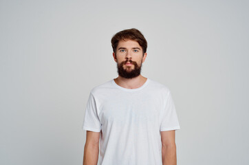 portrait of a bearded man white t-shirt studio cropped view