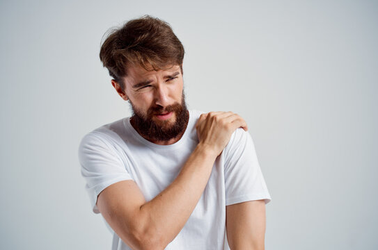 man in a white t-shirt stress medicine pain in the neck studio treatment