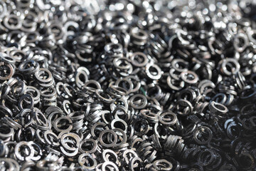Steel industrial grower in oil close-up. Spring-loaded circular split washer to prevent self-loosening of fasteners.