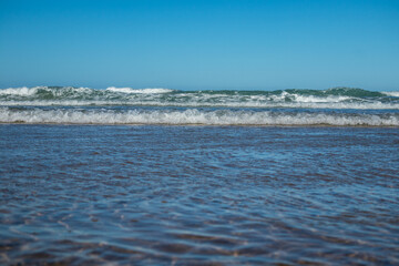 waves on the barrosa beach, at low tide, in sancti petri, cadiz