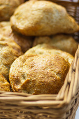Fresh loaves of rye or wheat breads in wicker basket