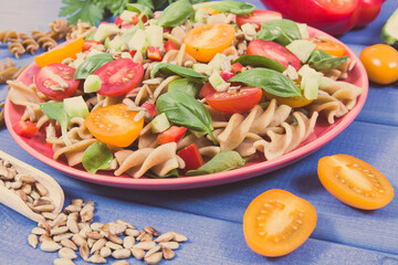 Salad with wholegrain pasta and vegetables. Healthy meal containing vitamins and minerals