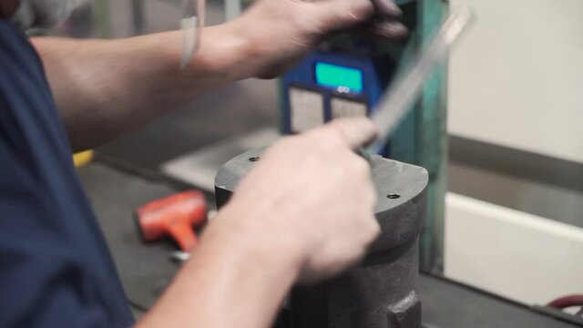 A closeup view of a locksmith working on the machine in HD