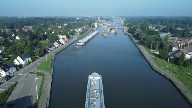 Fast forward drone aerial video flying over Albert canal and lock in Belgium. 3x speed