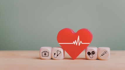 red heart and wooden block with medical and health icon for wellness, wellbeing and health insurance concept
