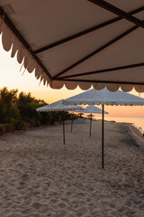 Beach umbrellas in the early summer morning on the beach on the Black Sea coast.