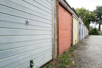 Old and weathered garages seen at a housing estate in the UK. The area is know for low level crime.