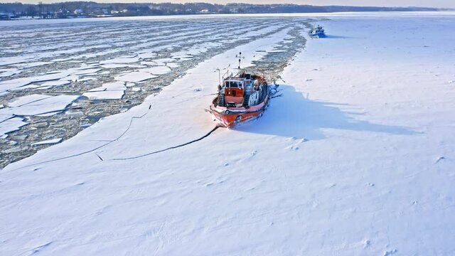 Icebreakers on Vistula river breaking ice. Aerial view of winter.