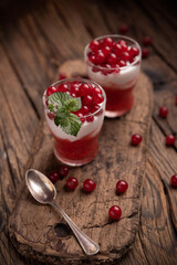 Smoothie made of red frozen berries in different small glasses