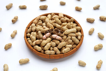 Raw peanuts on white background.