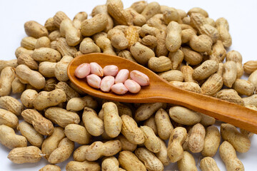 Raw peanuts on white background.