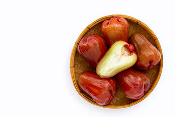 Fresh rose apple in bamboo basket on white background.