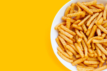 Prawn cracker sticks on yellow background. Shrimp crispy rice snack