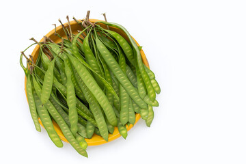 Naklejka premium Young fruit of Leucaena leucocepphala in yellow plate on white background.