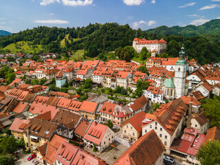 Fototapeta na wymiar Skofja Loka in Slovenia. Medieval Old Town, Bell Tower and Castle. Drone View
