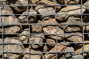 Natural stones in a metal lattice box 