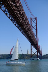 Portugal Lisbon - Ponte 25 de Abril suspension bridge and Sailing Boat