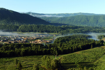 Village in the morning fog