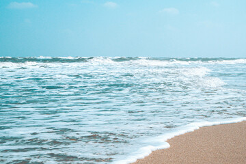 soft wave with bubble of blue ocean on white sand at tropical beach on summer season. simple beach background for summer. Bubble blue wave from sea to sand on the beach.summer background.