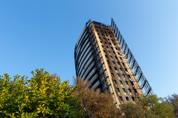 Milan, Italy - September 2, 2021: street view of the burned skyscraper Torre dei moro in Milan,...