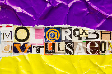 Torn and crumpled purple and yellow paper poster on bright colorful collage of magazine paper...
