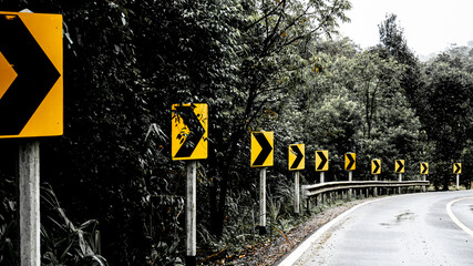 Signal turn right on country road in the woods and mountains. Road trip concept idea
