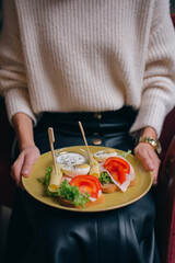 girl holding breakfast on plate