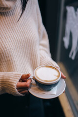 girl holding espresso with milk