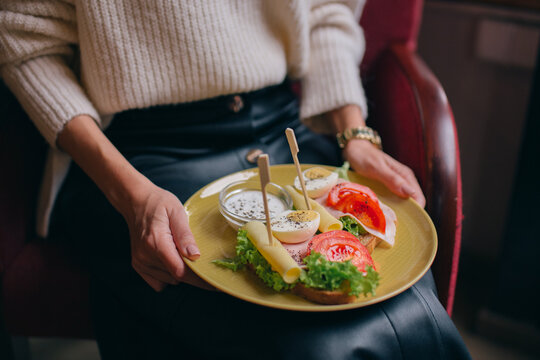 girl holding breakfast on plate
