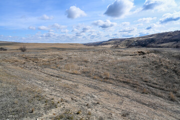 The mountains, steppes, bushes, grass and cloudy sky. Spring.