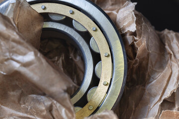 Large round bearing for electric locomotive repair. Close-up of a new shaft bearing in oiled wrapping paper.