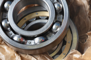 A set of large round bearings for the repair of an electric locomotive. Close-up of new bearings in oiled wrapping paper.