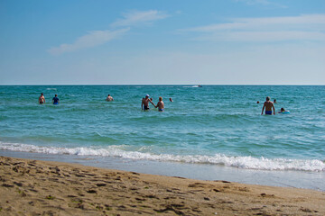 Group of tourists in the sea water. Relaxing by the sea during summer vacation.