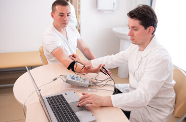 Fototapeta na wymiar Patient nerves testing using electromyography at medical center
