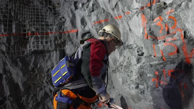  A miner marks the spot for drilling in an underground mine with paint.