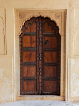 Traditional ornamental wooden door in Amber Fort, Mughal palace in Jaipur, India.