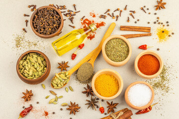 A set of spices for cooking curry. Aromatic condiments on light stone concrete background