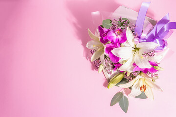 A beautiful bouquet of fresh flowers on a pink background