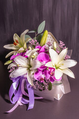 A beautiful bouquet of fresh flowers on a black wooden background