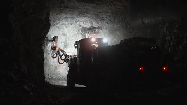 A drilling machine works in an underground mine.