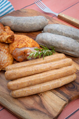 assorted barbecue meats on cutting board