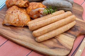assorted barbecue meats on cutting board