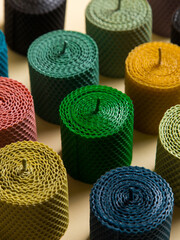 Colored, unusual handmade candles, of natural wax with texture of honeycomb bees, an element of the interior.