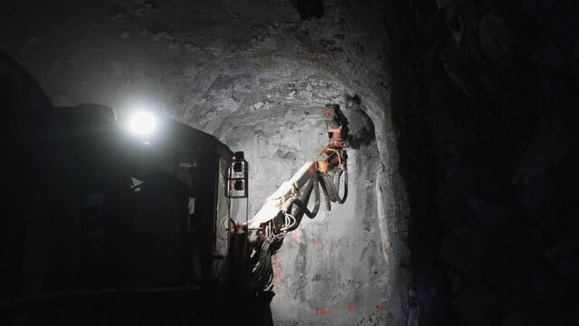 A drilling machine works in an underground mine.