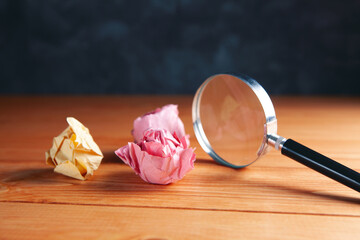 magnifying glass and crumpled papers on the table